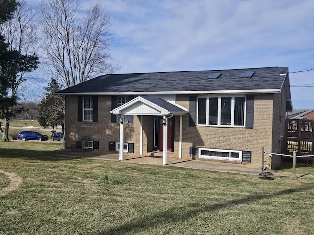 raised ranch featuring a front yard and a patio