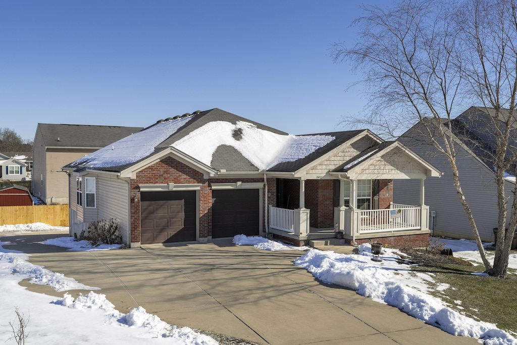 view of front of home featuring covered porch and a garage