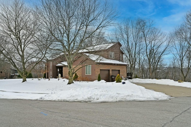 view of snowy exterior featuring a garage