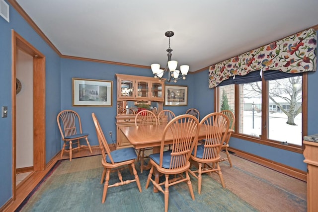 dining space with an inviting chandelier, ornamental molding, and dark hardwood / wood-style floors