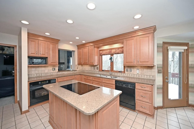 kitchen featuring black appliances, a center island, decorative backsplash, and sink