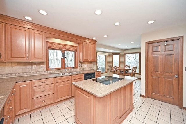 kitchen featuring black appliances, a kitchen island, decorative backsplash, sink, and light tile patterned floors