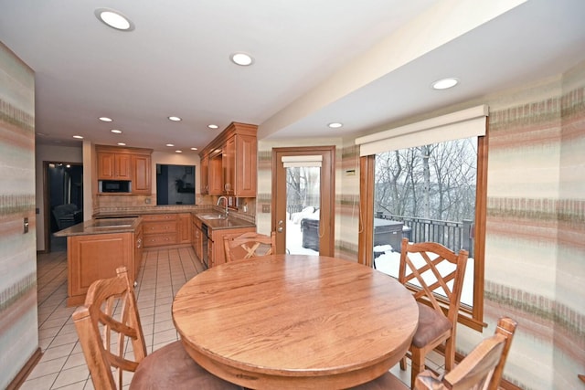 dining room with sink and light tile patterned floors