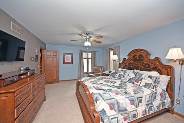 bedroom featuring light colored carpet and ceiling fan