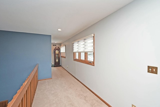 hallway with light colored carpet