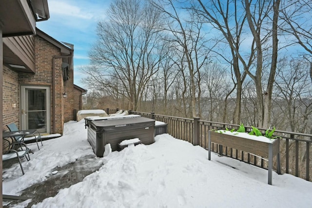 snowy yard featuring a hot tub