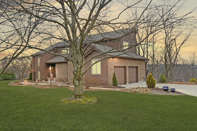 view of front of home with a garage and a yard