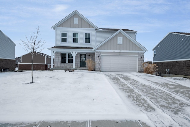 view of front facade featuring a garage and central AC