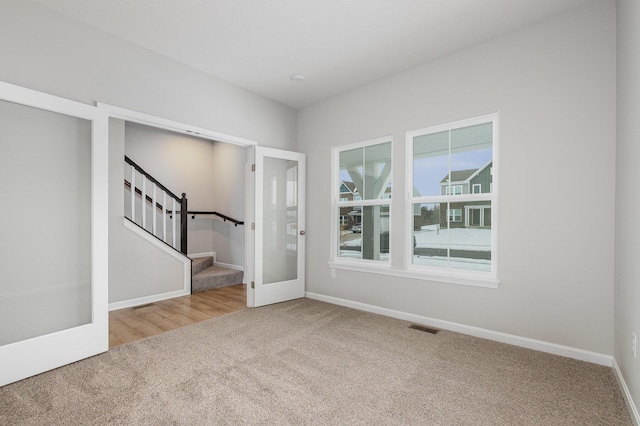 carpeted empty room with french doors