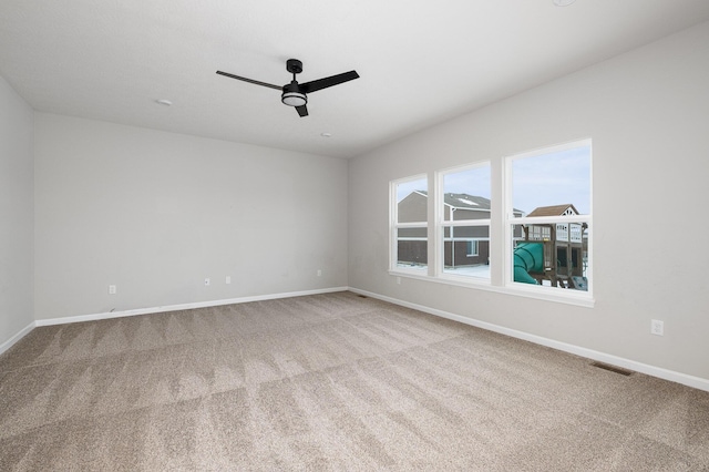 carpeted empty room featuring ceiling fan