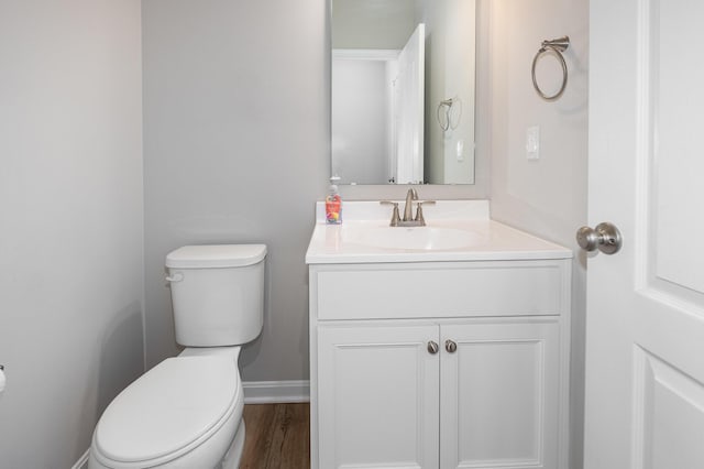 bathroom featuring vanity, hardwood / wood-style flooring, and toilet