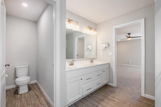 bathroom featuring hardwood / wood-style flooring, vanity, and toilet