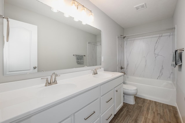 full bathroom with wood-type flooring, bathing tub / shower combination, vanity, and toilet