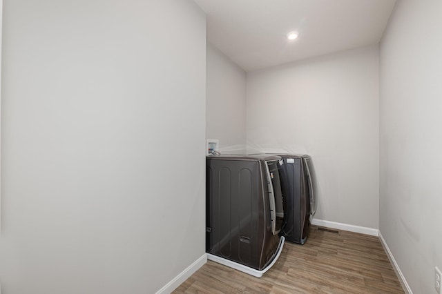 washroom with washer / dryer and wood-type flooring