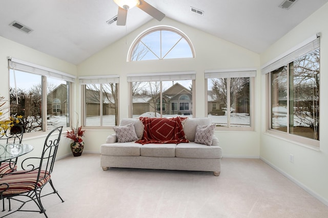 sunroom / solarium with ceiling fan, vaulted ceiling, and a wealth of natural light