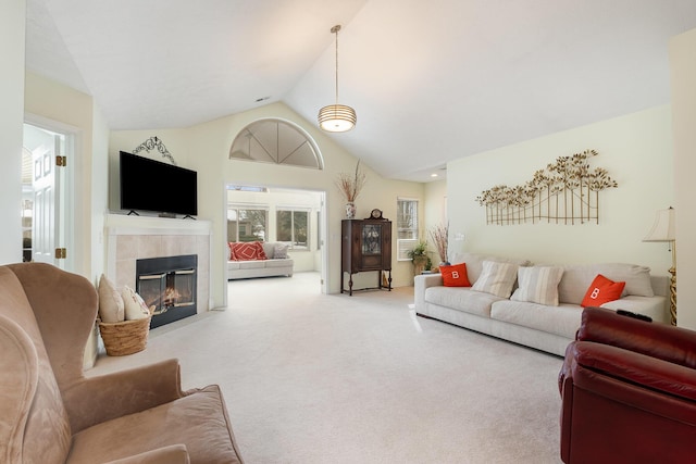 carpeted living room featuring lofted ceiling and a fireplace