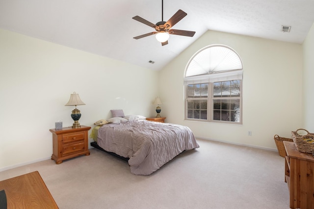 bedroom with ceiling fan, light colored carpet, and lofted ceiling