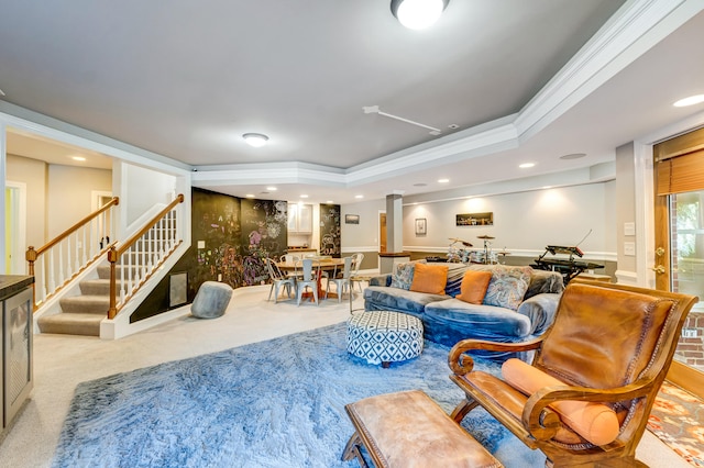 carpeted living room with crown molding, a raised ceiling, and ornate columns