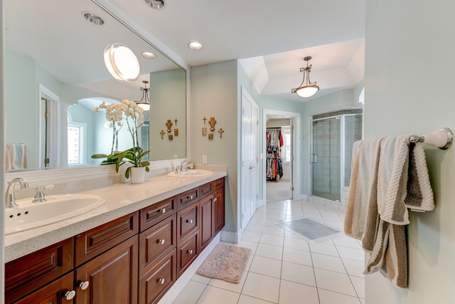 bathroom featuring walk in shower, vanity, and tile patterned flooring