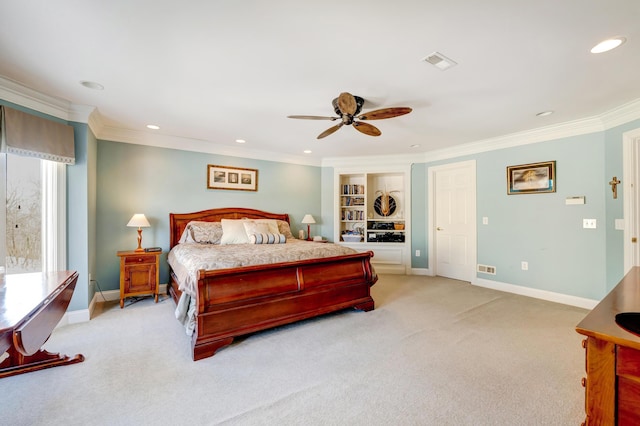 bedroom featuring ornamental molding, light colored carpet, and ceiling fan