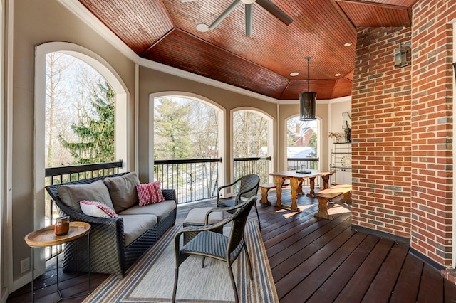 wooden deck with an outdoor hangout area and ceiling fan