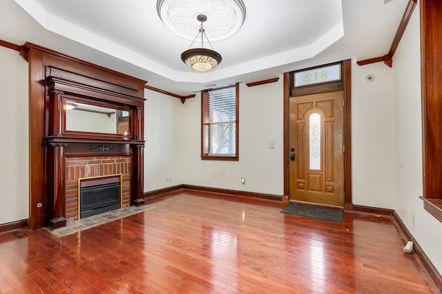 foyer featuring hardwood / wood-style flooring and a tray ceiling