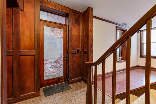 foyer entrance featuring ornamental molding