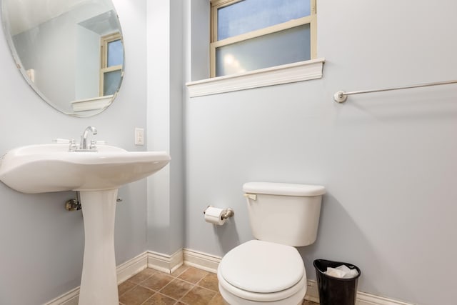 bathroom with toilet and tile patterned flooring