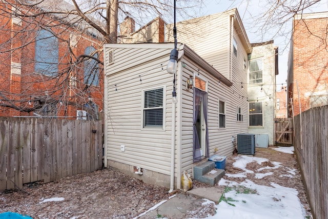 view of snowy exterior with central AC