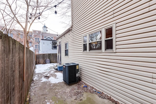 view of side of home with central air condition unit