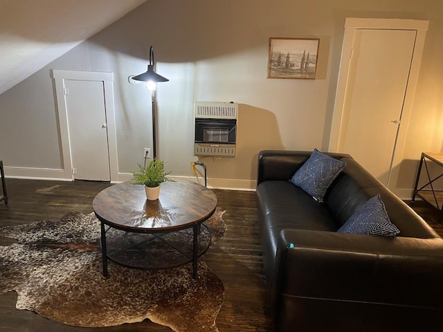 living room featuring heating unit, lofted ceiling, and dark hardwood / wood-style floors