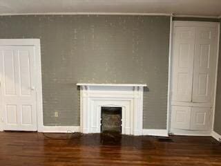 unfurnished living room featuring dark hardwood / wood-style floors