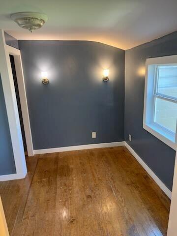 unfurnished room with hardwood / wood-style flooring