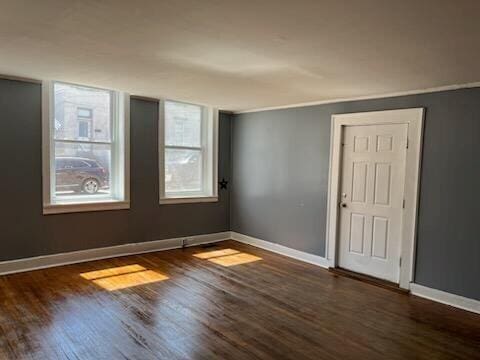 unfurnished room featuring dark wood-type flooring