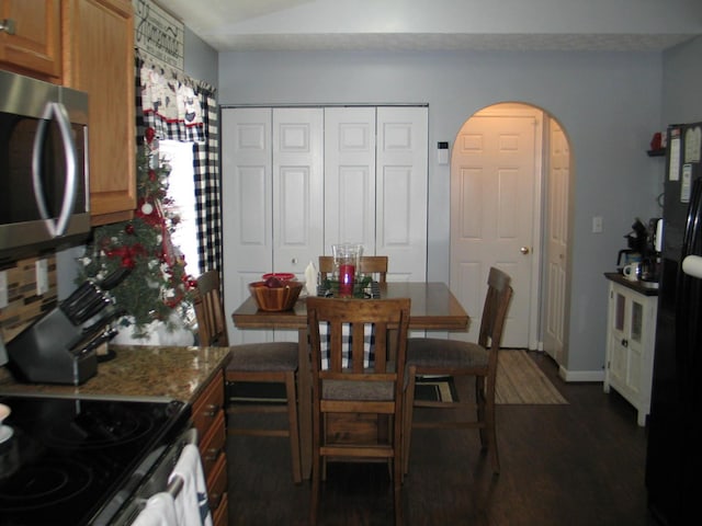 dining area with dark wood-type flooring