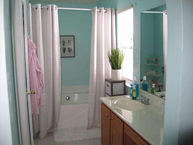 bathroom featuring vanity, shower with separate bathtub, and tile patterned flooring