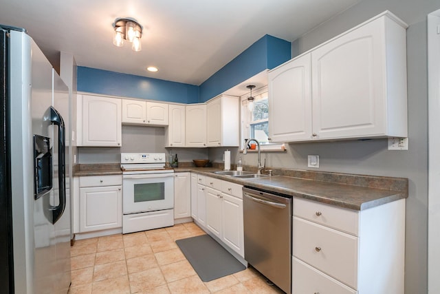 kitchen with stainless steel appliances, white cabinetry, sink, and light tile patterned floors