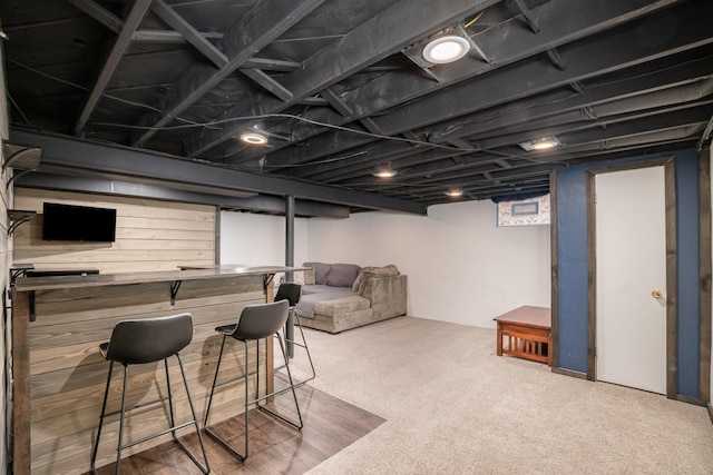 interior space with bar, carpet floors, and wood walls