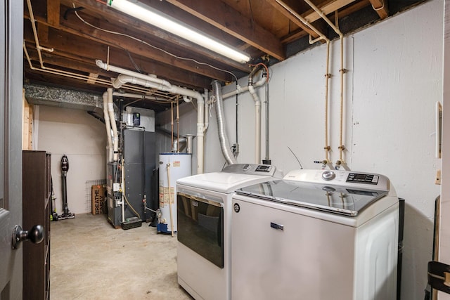 washroom with gas water heater, heating unit, and washing machine and dryer