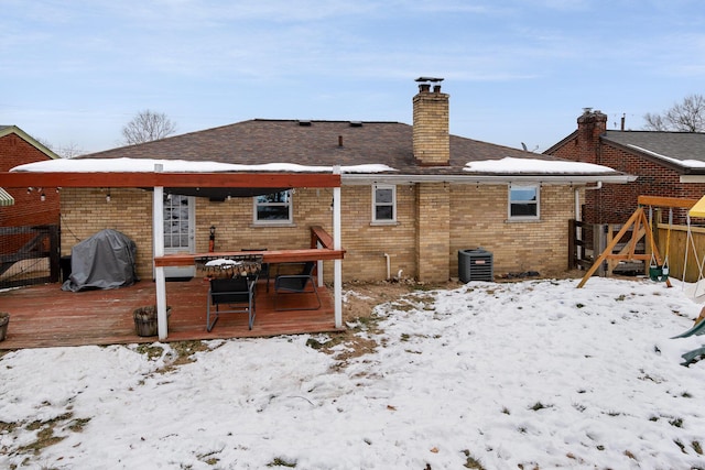 snow covered house featuring a deck and central air condition unit