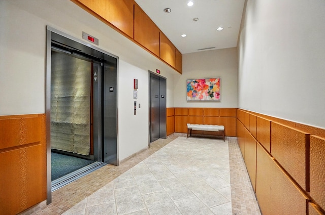 400 Riverboat Row Unit 605, Newport, KY 41071 - corridor with elevator, light tile patterned flooring, wainscoting, and recessed lighting