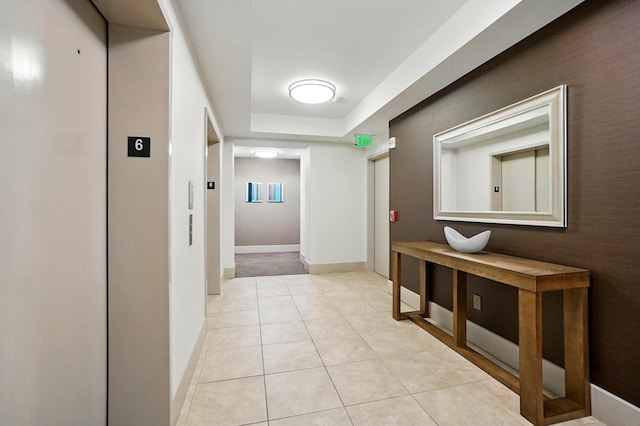 400 Riverboat Row Unit 605, Newport, KY 41071 - hall featuring elevator, light tile patterned floors, a tray ceiling, and baseboards