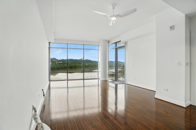 400 Riverboat Row Unit 605, Newport, KY 41071 - empty room featuring floor to ceiling windows, wood finished floors, a water view, ceiling fan, and baseboards