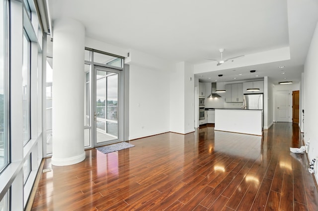 400 Riverboat Row Unit 605, Newport, KY 41071 - unfurnished living room featuring dark wood-type flooring, a ceiling fan, ornate columns, and baseboards