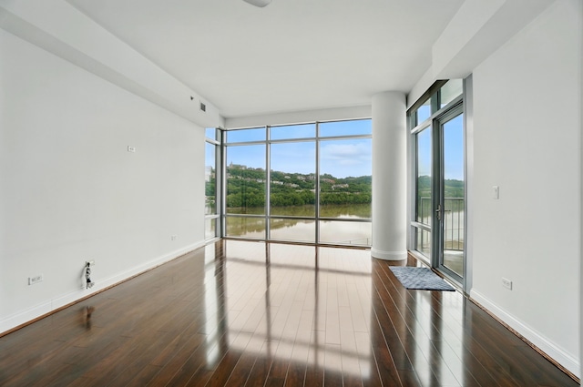 400 Riverboat Row Unit 605, Newport, KY 41071 - unfurnished room with healthy amount of natural light, hardwood / wood-style floors, and baseboards