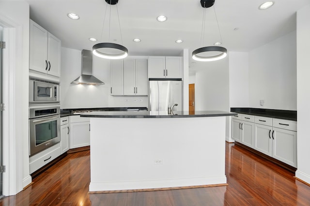 400 Riverboat Row Unit 605, Newport, KY 41071 - kitchen with wall chimney exhaust hood, appliances with stainless steel finishes, dark countertops, and recessed lighting