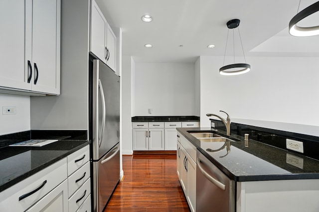 400 Riverboat Row Unit 605, Newport, KY 41071 - kitchen with appliances with stainless steel finishes, a sink, dark wood-style floors, recessed lighting, and dark stone countertops