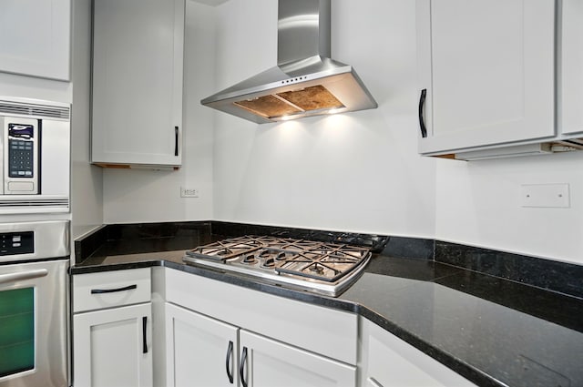 400 Riverboat Row Unit 605, Newport, KY 41071 - kitchen with wall chimney range hood, stainless steel appliances, white cabinets, and dark stone counters