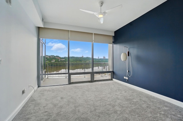 400 Riverboat Row Unit 605, Newport, KY 41071 - carpeted spare room featuring a water view, ceiling fan, baseboards, and expansive windows