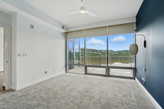 400 Riverboat Row Unit 605, Newport, KY 41071 - empty room featuring a ceiling fan, carpet flooring, baseboards, and a water view